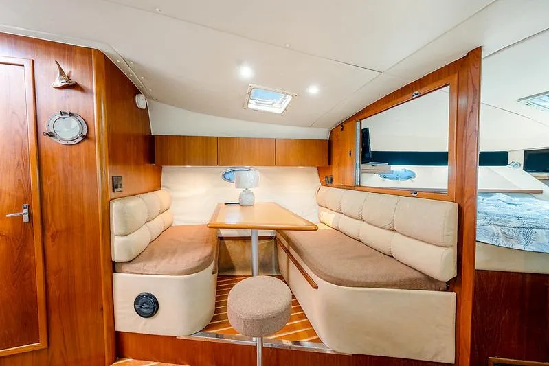 Slide: The Image of Interior of 2000 Tiara 3500 EXPRESS yacht with cozy seating and wooden finishes. - 40