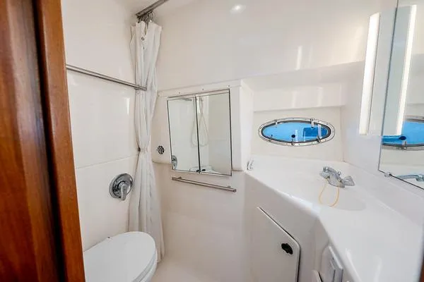 Slide: The Image of Bathroom interior of 2000 Tiara 3500 EXPRESS yacht, featuring shower and porthole window. - 42