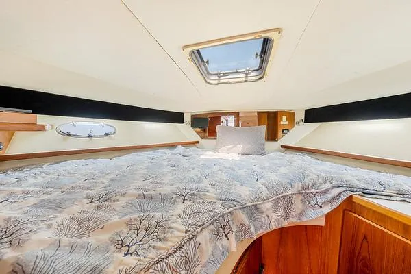 Slide: The Image of Cozy cabin interior of 2000 Tiara 3500 EXPRESS yacht with skylight and patterned bedding. - 43