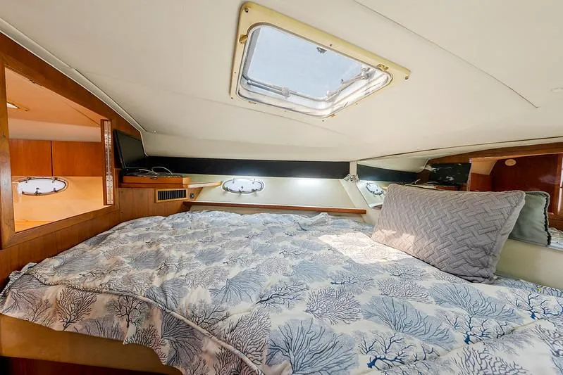 Slide: The Image of Cozy cabin interior of 2000 Tiara 3500 EXPRESS yacht with skylight and patterned bedding. - 44