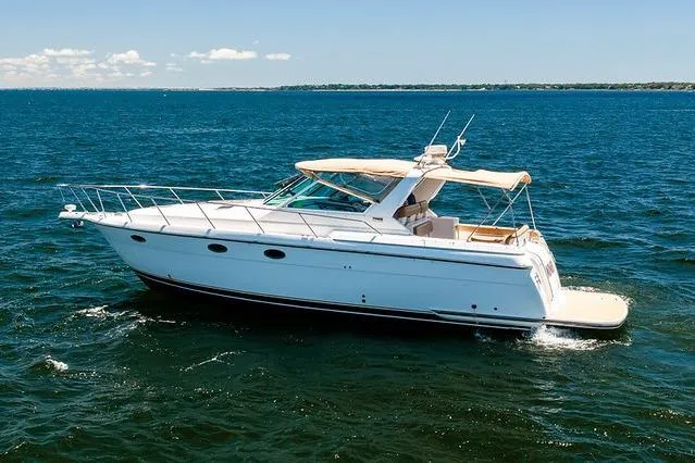 Slide: The Image of 2000 Tiara 3500 EXPRESS yacht cruising on open water under clear skies. - 5