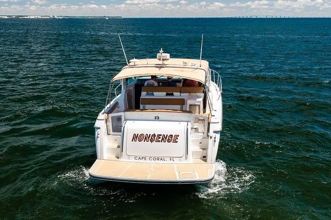 Slide: The Image of 2000 Tiara 3500 EXPRESS yacht named "Nonsense" cruising in open water. - 7