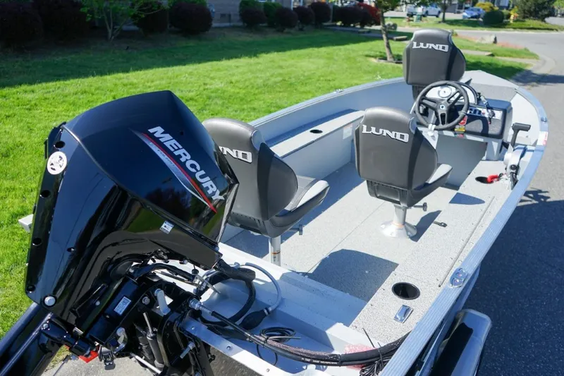 Slide: The Image of 2026 Lund 1400 Fury SS boat with Mercury engine, featuring two seats and steering wheel. - 4