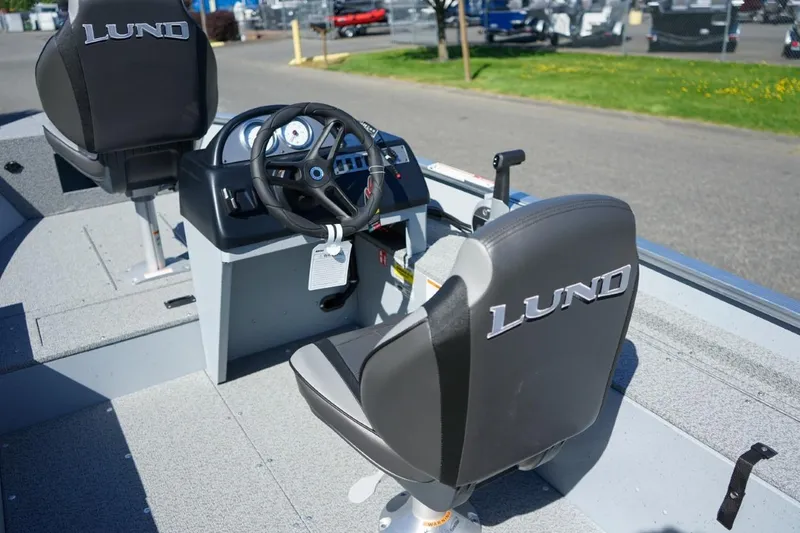 Slide: The Image of 2026 Lund 1400 Fury SS boat interior with steering wheel and branded seats. - 5