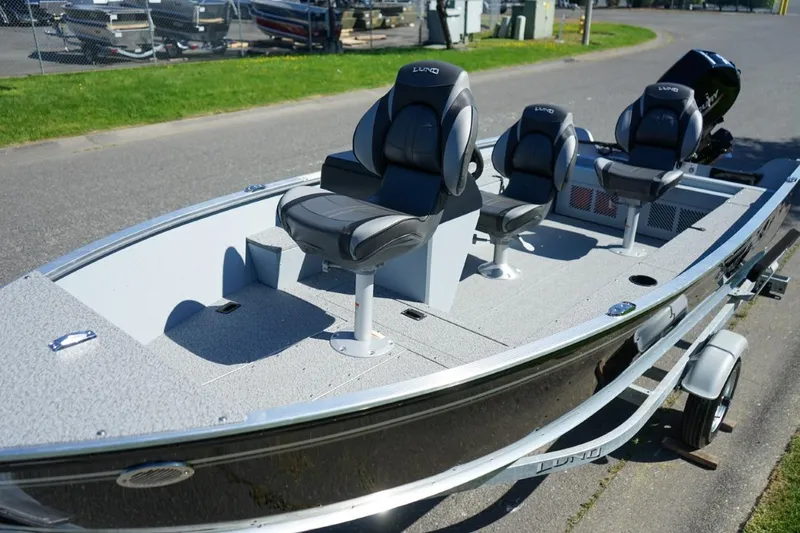 Slide: The Image of 2026 Lund 1400 Fury SS fishing boat with three seats on a trailer. - 7
