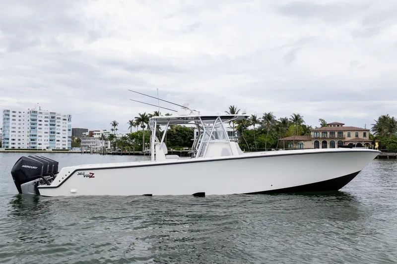 Slide: The Image of 2018 SeaVee 390Z boat on water, with Mercury engines, near waterfront homes. - 1