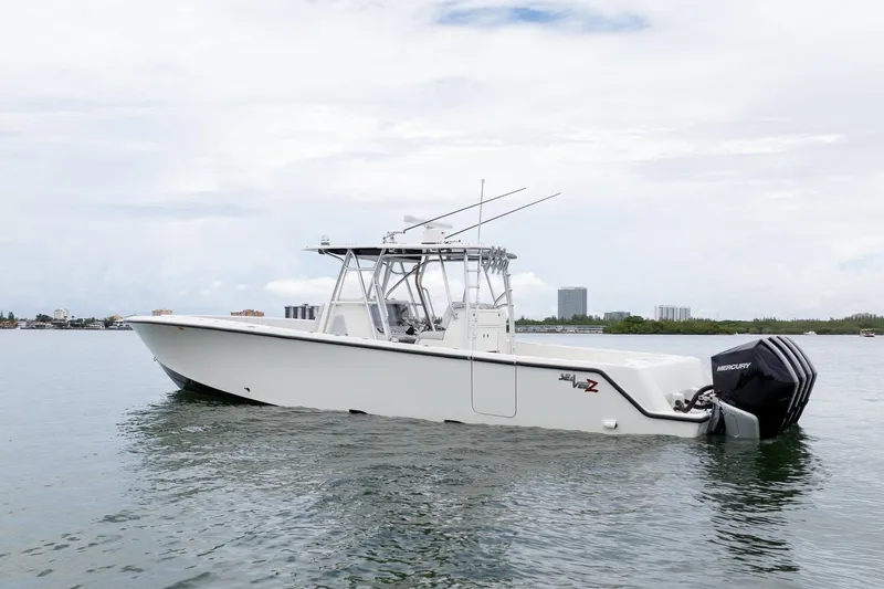 Slide: The Image of 2018 SeaVee 390Z boat on calm water with triple Mercury engines. - 10