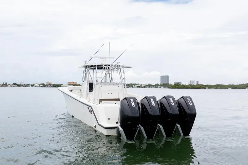 Slide: The Image of 2018 SeaVee 390Z boat with four powerful outboard engines on calm water. - 11