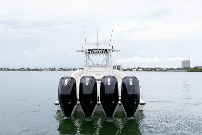 Slide: The Image of 2018 SeaVee 390Z boat with four powerful outboard engines on calm water. - 12