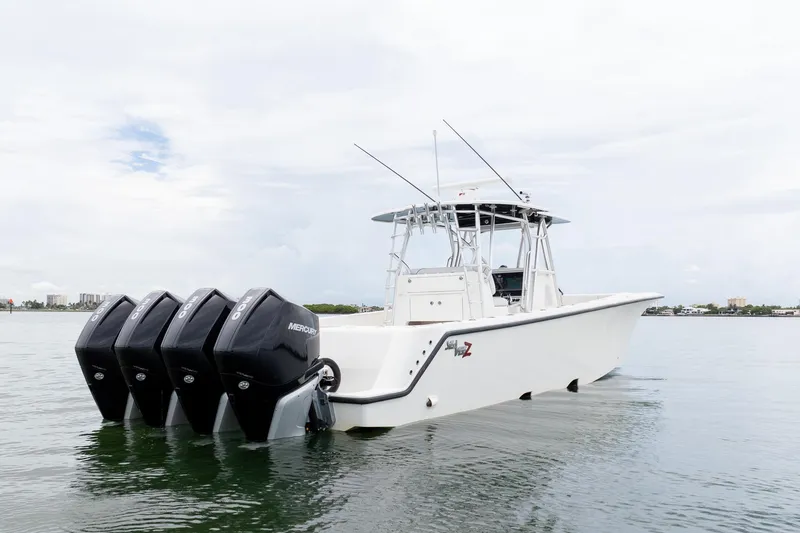 Slide: The Image of 2018 SeaVee 390Z boat with four Mercury outboard engines on calm water. - 13