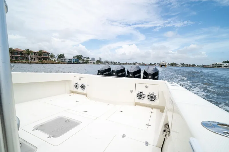 Slide: The Image of 2018 SeaVee 390Z boat with multiple Mercury engines cruising on a scenic waterway. - 17