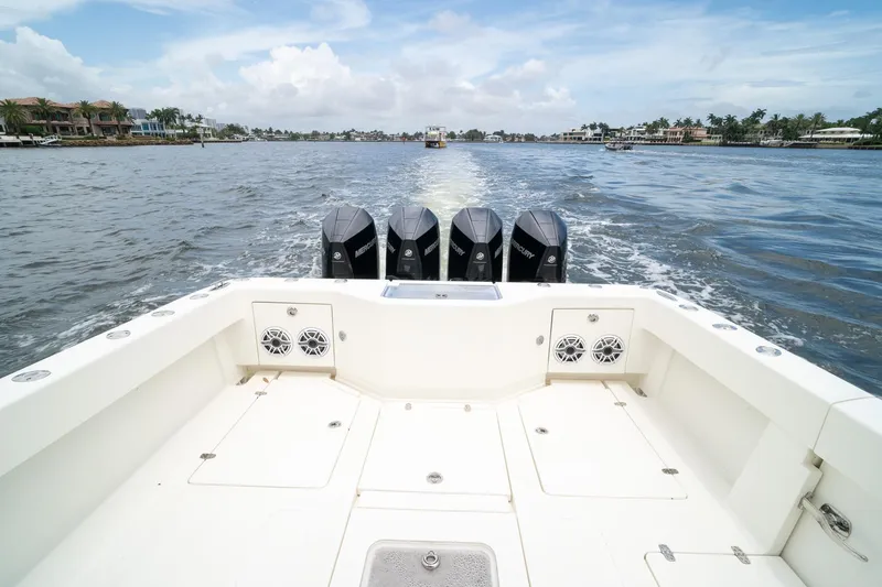 Slide: The Image of 2018 SeaVee 390Z boat with four outboard engines cruising on a scenic waterway. - 18