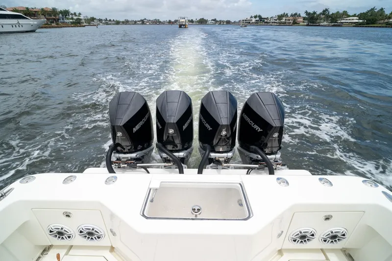 Slide: The Image of 2018 SeaVee 390Z boat with four Mercury outboard engines cruising on water. - 19