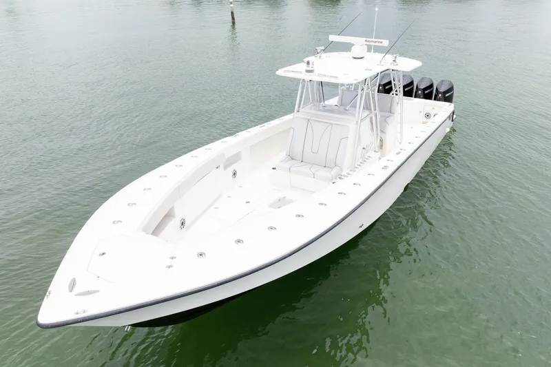 Slide: The Image of 2018 SeaVee 390Z boat on calm water, featuring sleek design and multiple outboard engines. - 2