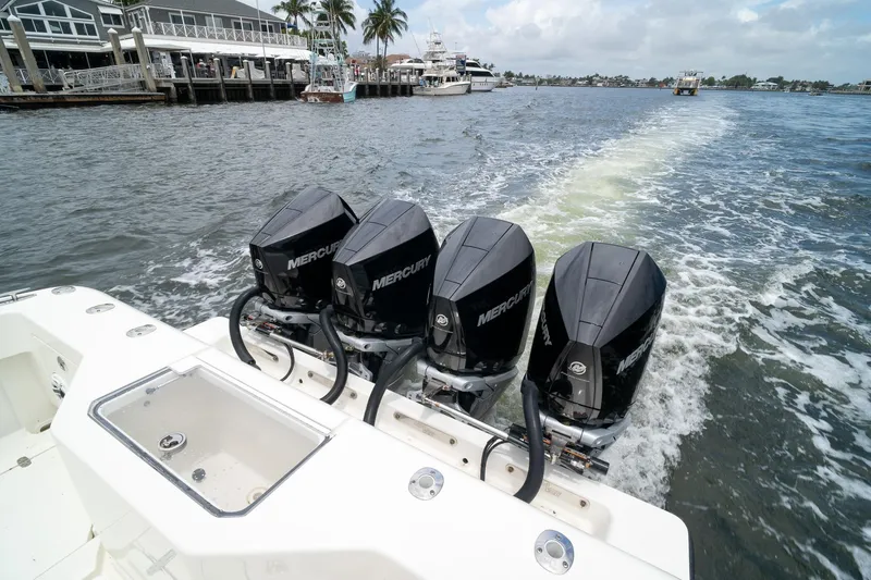 Slide: The Image of 2018 SeaVee 390Z boat with four Mercury outboard engines cruising on water. - 21
