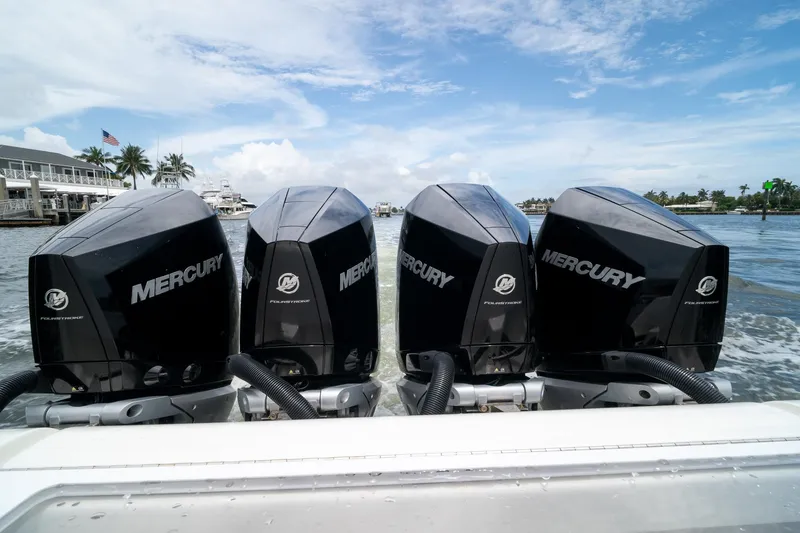 Slide: The Image of Four Mercury outboard engines on a 2018 SeaVee 390Z boat in a marina setting. - 22