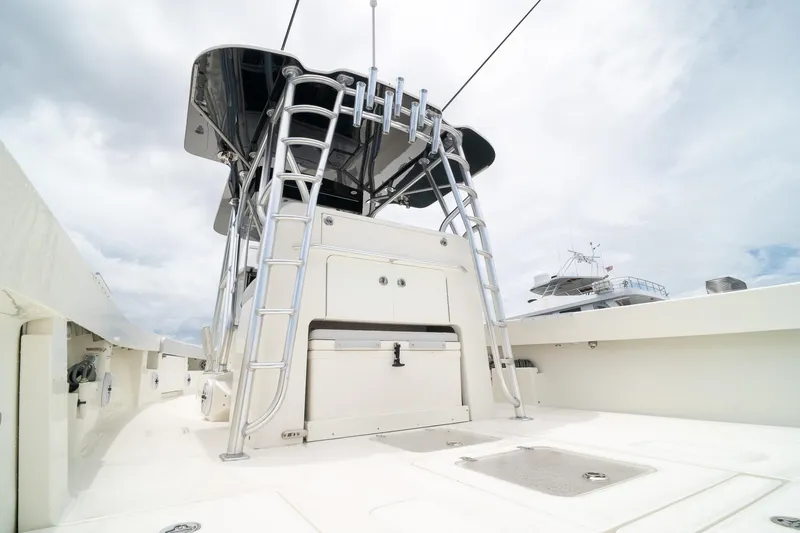 Slide: The Image of 2018 SeaVee 390Z boat deck with ladder and storage, under cloudy sky. - 27