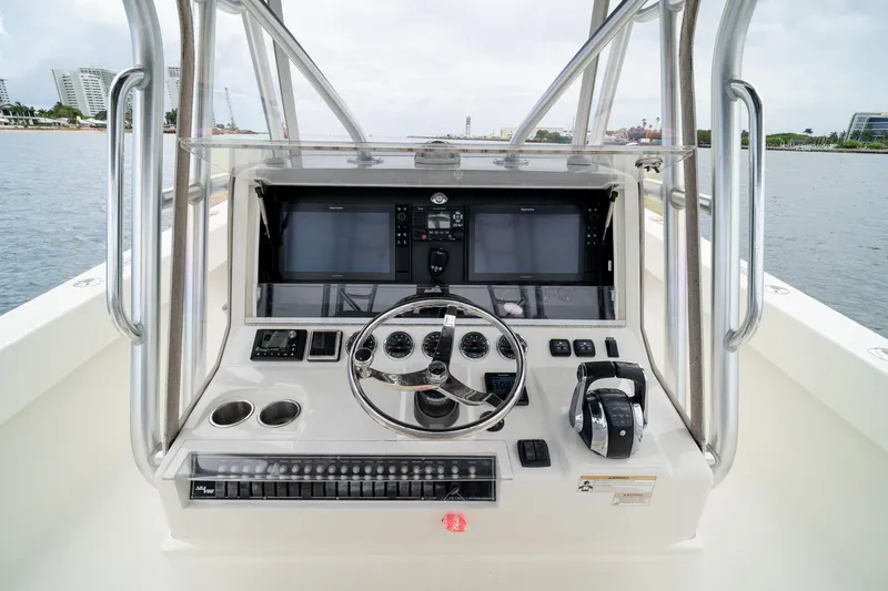 Slide: The Image of 2018 SeaVee 390Z boat console with steering wheel and navigation screens. - 29