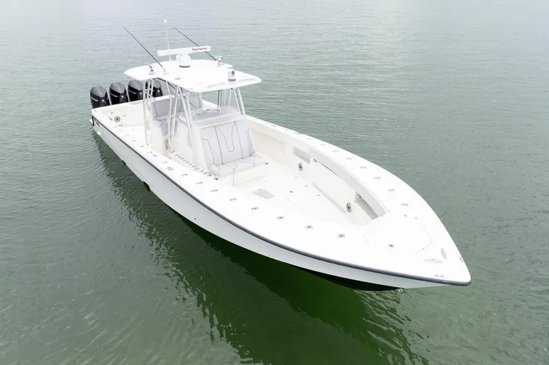 Slide: The Image of 2018 SeaVee 390Z boat on calm water, featuring sleek design and multiple outboard engines. - 3