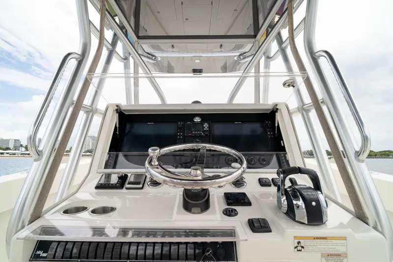 Slide: The Image of 2018 SeaVee 390Z boat helm with steering wheel, controls, and navigation display. - 30