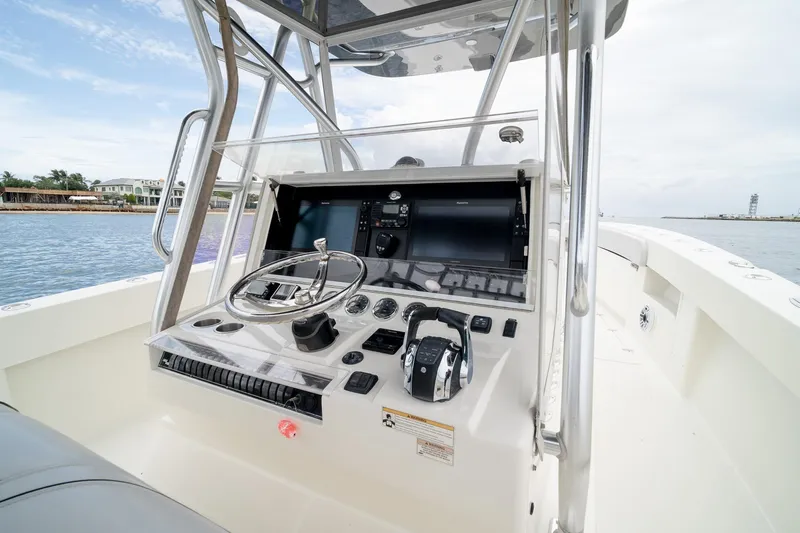 Slide: The Image of 2018 SeaVee 390Z boat helm with steering wheel and navigation controls. - 31