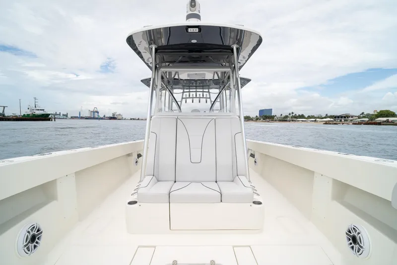 Slide: The Image of 2018 SeaVee 390Z boat interior with seating, docked by the waterfront. - 38