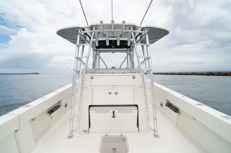 Slide: The Image of 2018 SeaVee 390Z boat with ladder and console, on calm waters under cloudy sky. - 44