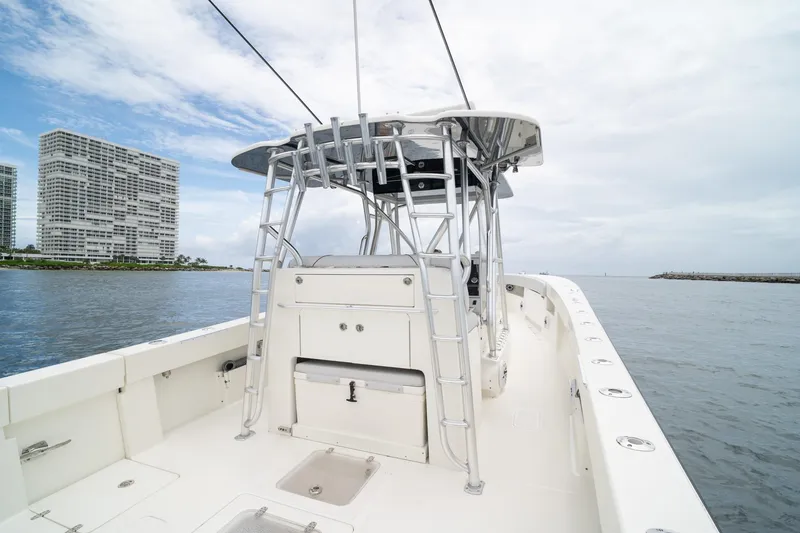 Slide: The Image of 2018 SeaVee 390Z boat on water, with cityscape background and clear sky. - 45