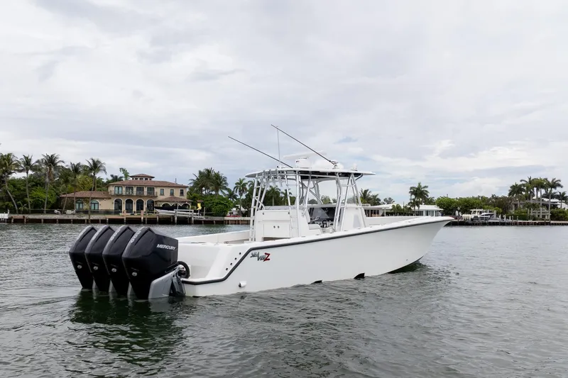Slide: The Image of 2018 SeaVee 390Z boat with four Mercury engines on a calm waterway. - 5