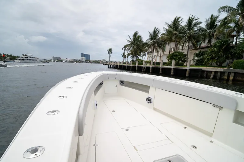 Slide: The Image of 2018 SeaVee 390Z boat on calm water, surrounded by palm trees and luxury homes. - 55