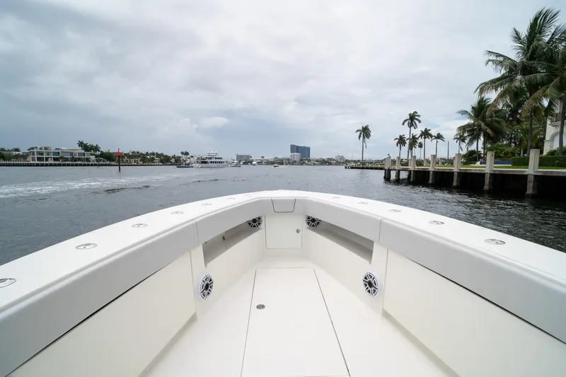 Slide: The Image of 2018 SeaVee 390Z boat cruising on a scenic waterway with palm trees. - 56