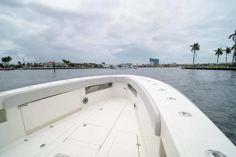 Slide: The Image of 2018 SeaVee 390Z boat on calm waters with palm trees and cloudy sky. - 57