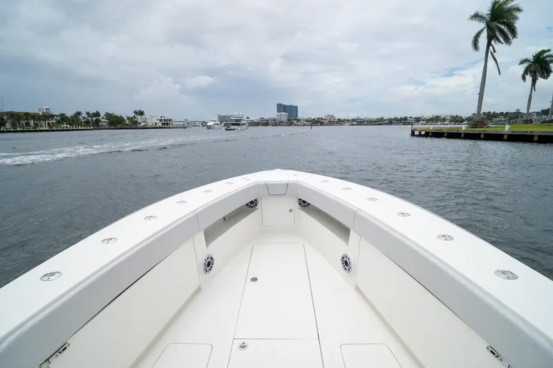 Slide: The Image of Bow view of 2018 SeaVee 390Z boat on a calm waterway with palm trees. - 58