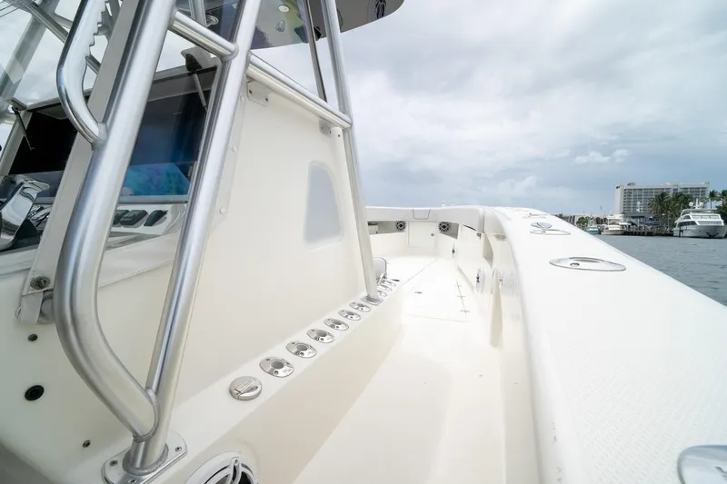 Slide: The Image of 2018 SeaVee 390Z boat deck with stainless steel railings, docked by the waterfront. - 63
