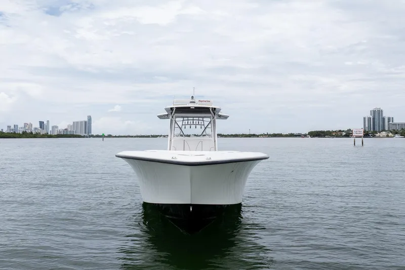 Slide: The Image of 2018 SeaVee 390Z boat on calm water with city skyline in background. - 7
