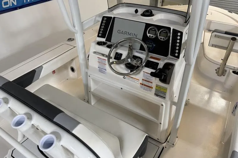Slide: The Image of 2026 Robalo 226 Cayman boat cockpit with Garmin navigation system and steering wheel. - 10
