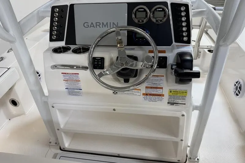 Slide: The Image of 2026 Robalo 226 Cayman boat dashboard with Garmin navigation system and controls. - 11