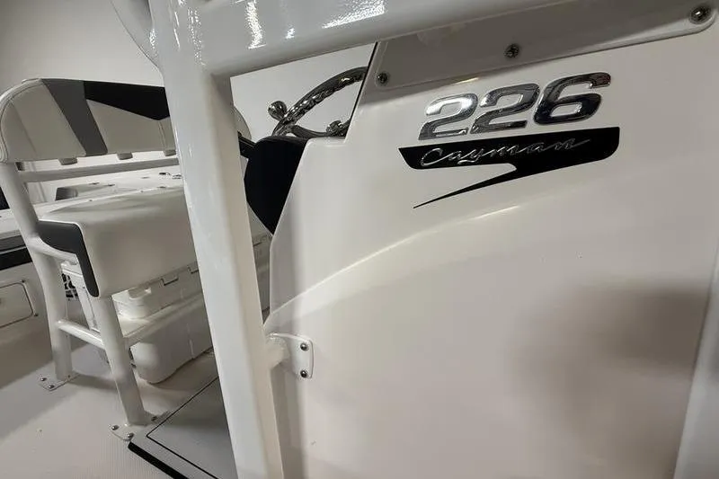 Slide: The Image of 2026 Robalo 226 Cayman boat interior with steering wheel and seating. - 12