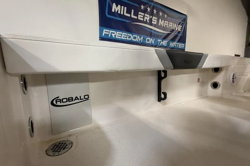 Slide: The Image of 2026 Robalo 226 Cayman boat interior at Miller's Marine showroom. - 13