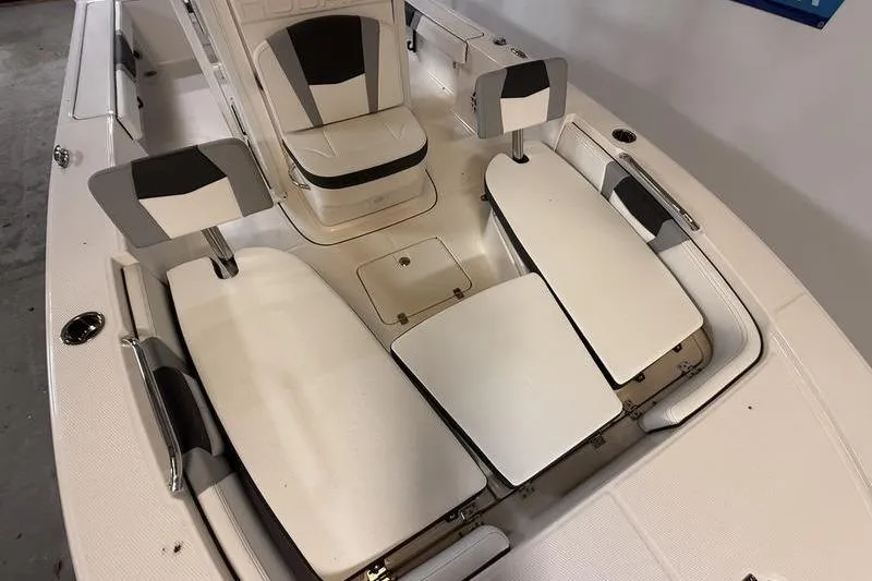 Slide: The Image of 2026 Robalo 226 Cayman boat interior with white and black seating arrangement. - 14