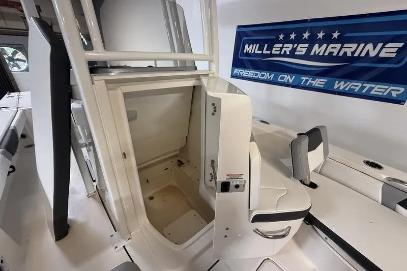 Slide: The Image of 2026 Robalo 226 Cayman boat interior with storage compartment, showcased at Miller's Marine. - 15