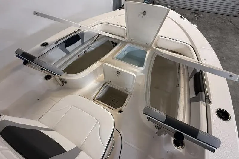 Slide: The Image of 2026 Robalo 226 Cayman boat interior with storage compartments and seating. - 17