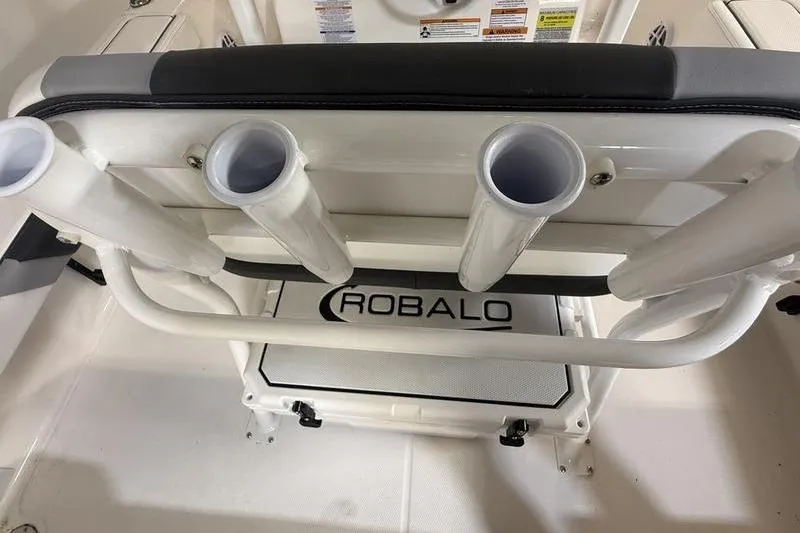 Slide: The Image of 2026 Robalo 226 Cayman boat interior with rod holders and branded mat. - 9