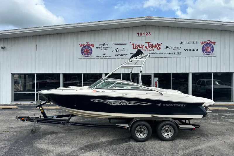 The Image of 2008 Monterey 194FS boat on trailer outside dealership, showcasing sleek design and branding. - 1