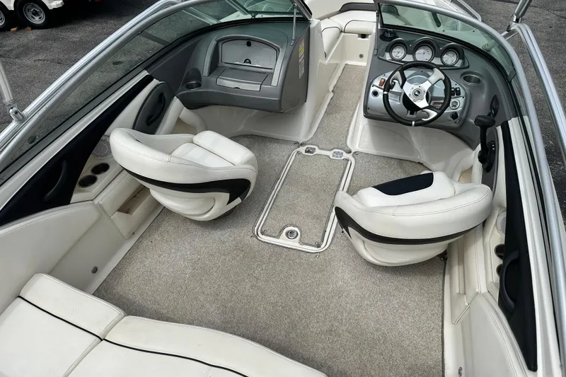Slide: The Image of 2008 Monterey 194FS boat interior with white seating and modern dashboard. - 10