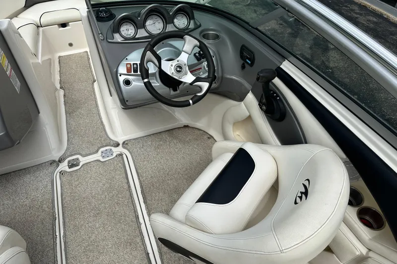 Slide: The Image of Interior of a 2008 Monterey 194FS boat, featuring steering wheel and dashboard controls. - 11
