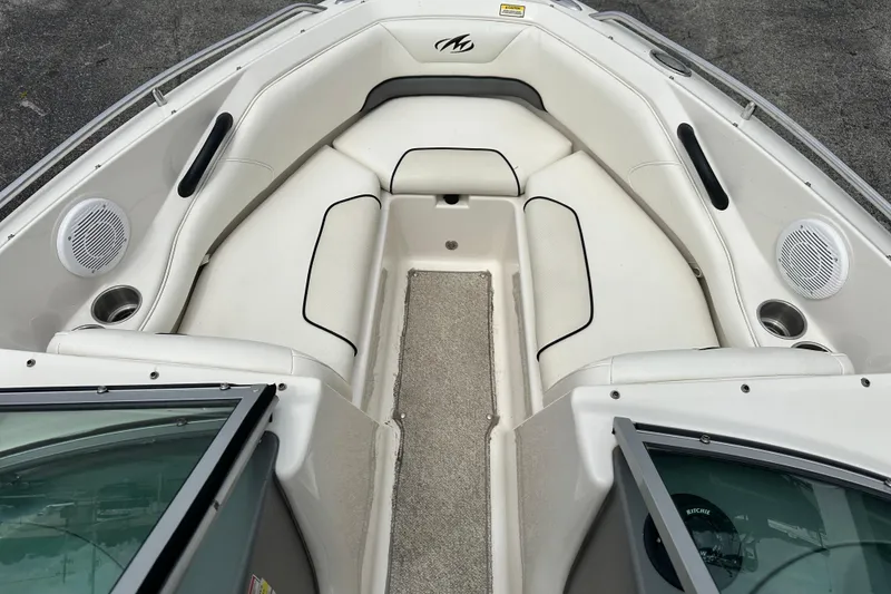 Slide: The Image of 2008 Monterey 194FS boat interior with white seating and speakers. - 14
