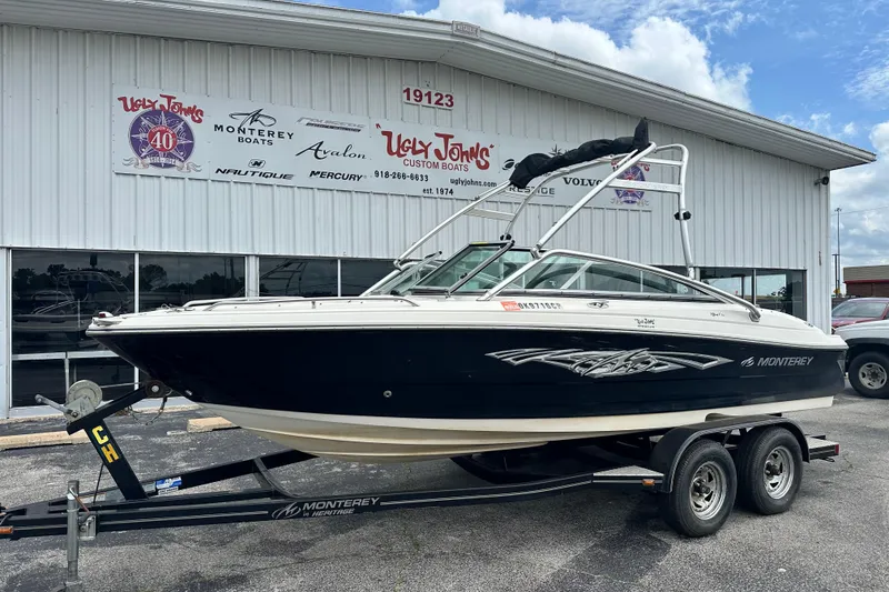 Slide: The Image of 2008 Monterey 194FS boat on trailer outside dealership, featuring sleek design and custom graphics. - 2
