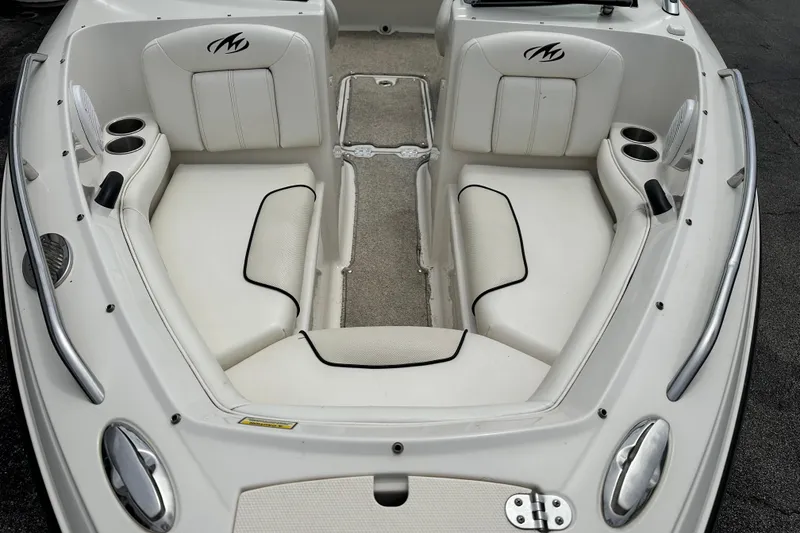 Slide: The Image of 2008 Monterey 194FS boat interior with white seating and cup holders. - 6