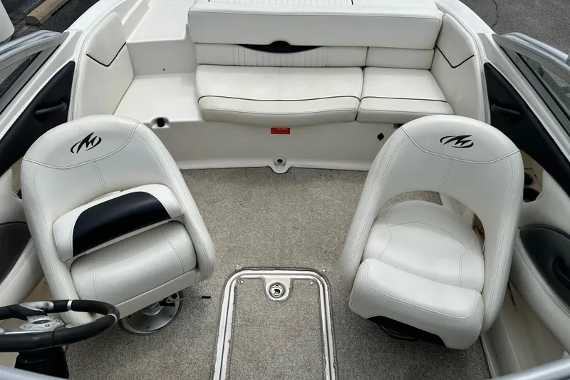 Slide: The Image of Interior of a 2008 Monterey 194FS boat with white seating and carpeted floor. - 7